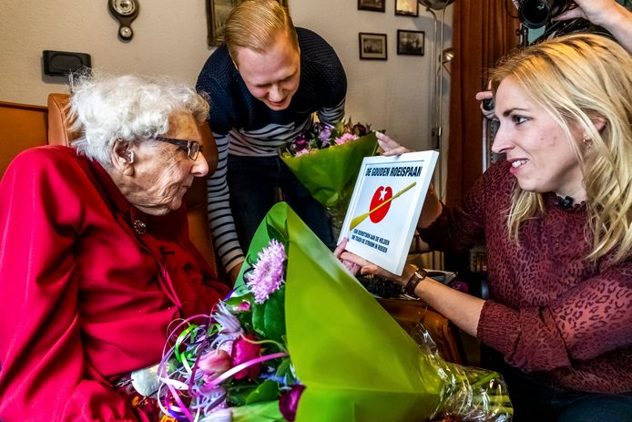 Mevrouw Piël ontvangt De Gouden Roeispaan uit de handen van tweede kamerlid Lilian Marijnissen (SP). In het midden haar voormalige buurman Wouter.