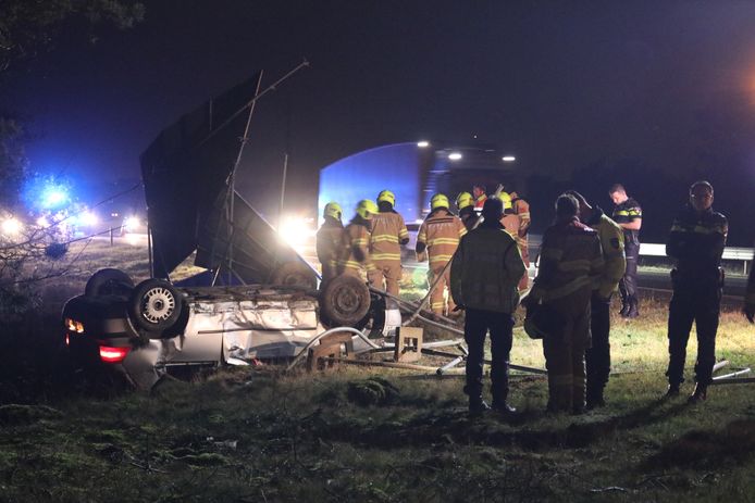 De gecrashte auto in de berm naast het kapotte verkeersbord.