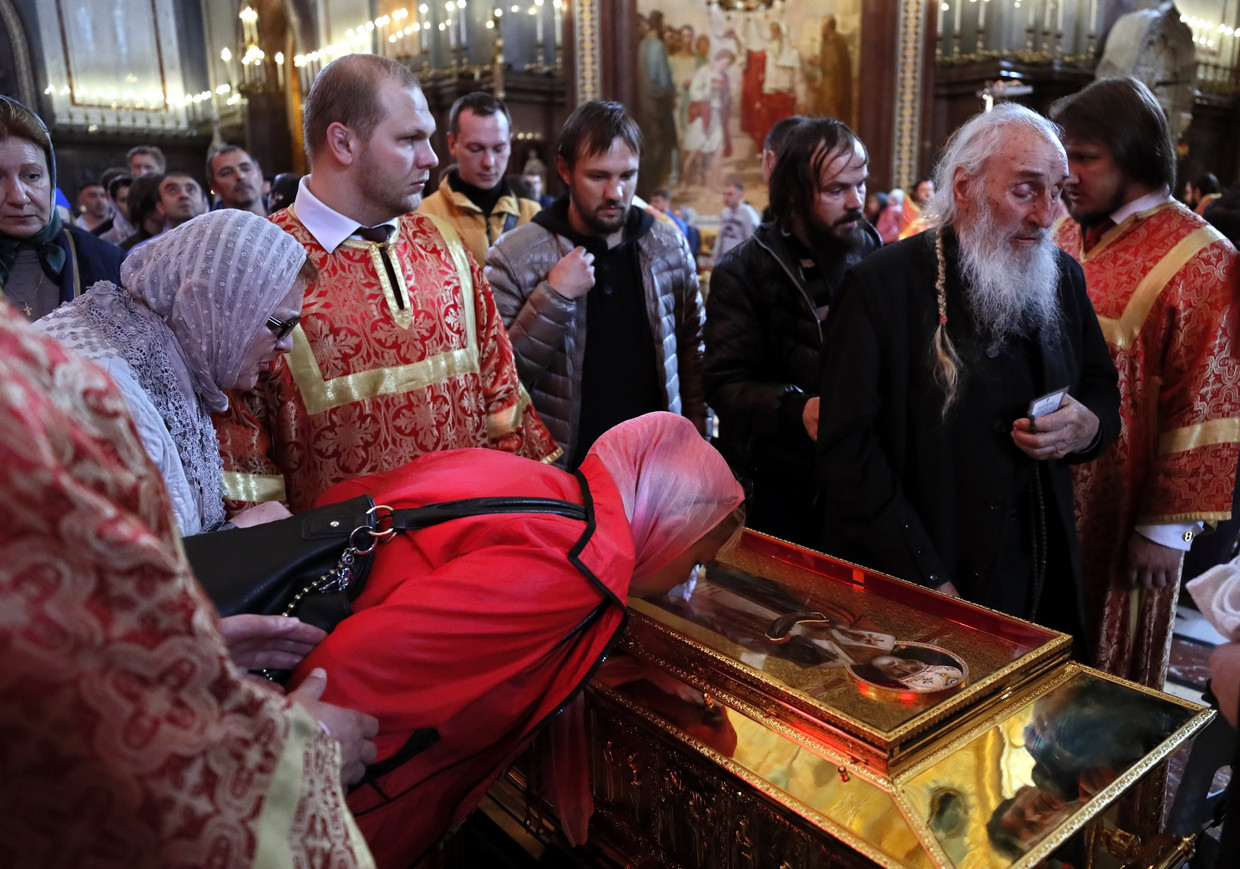 Russisch-orthodoxen kussen een grafkist die het lichaam van Sint Nicolaas zou bevatten. Over welke kist de echte is, verschillen de meningen. Beeld EPA