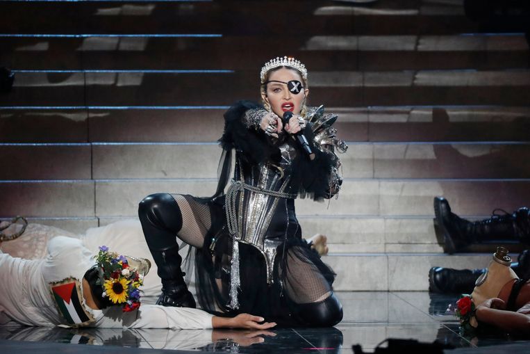 Madonna tijdens haar gastoptreden op het Eurovisiesongfestival in Tel Aviv in 2019. Links op de grond ligt een danser met op zijn rug de Palestijnse vlag.  Beeld Getty Images