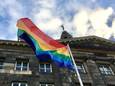 De regenboogvlag wappert op het stadhuis