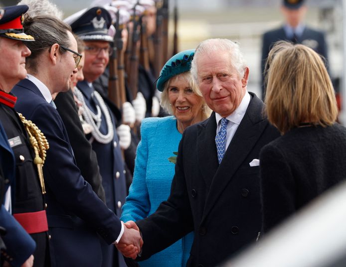 Britain's King Charles III (2R) shakes hands next to  Britain's Camilla, Queen Consort and British Ambassador to Germany Jill Gallard (R) after landing at Berlin Brandenburg Airport in Schoenefeld near Berlin, on March 29, 2023. - Britain's King Charles III began his first state visit, having postponed a trip to France due to widespread political protests. Charles will undertake engagements in the German capital and in Brandenburg before heading to Hamburg during the three-day tour. (Photo by Odd ANDERSEN / AFP)