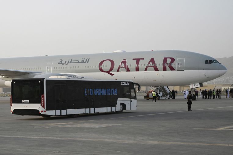 A shuttle bus carrying passengers move toward the Qatar Airways aircraft bound to Qatar at the airport in Kabul on September 10, 2021. - A second charter flight left Afghanistan on September 10 carrying foreigners and Afghans to Qatar in a sign the country's main airport was close to resuming commercial operations, as the United Nations warned of 