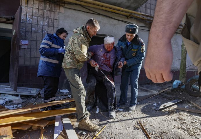 Mensen helpen een man die gewond raakte bij een bombardement op de Oost-Oekraïense stad Donetsk.