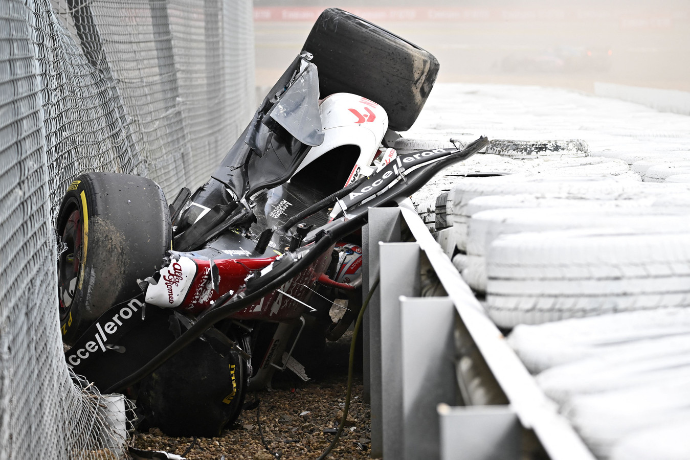 TOPSHOT - Alfa Romeo Chinese driver Zhou Guanyu is seen in the crash barriers during an incident at the star during the Formula One British Grand Prix at the Silverstone motor racing circuit in Silverstone, central England on July 3, 2022. (Photo by Ben Stansall / AFP)