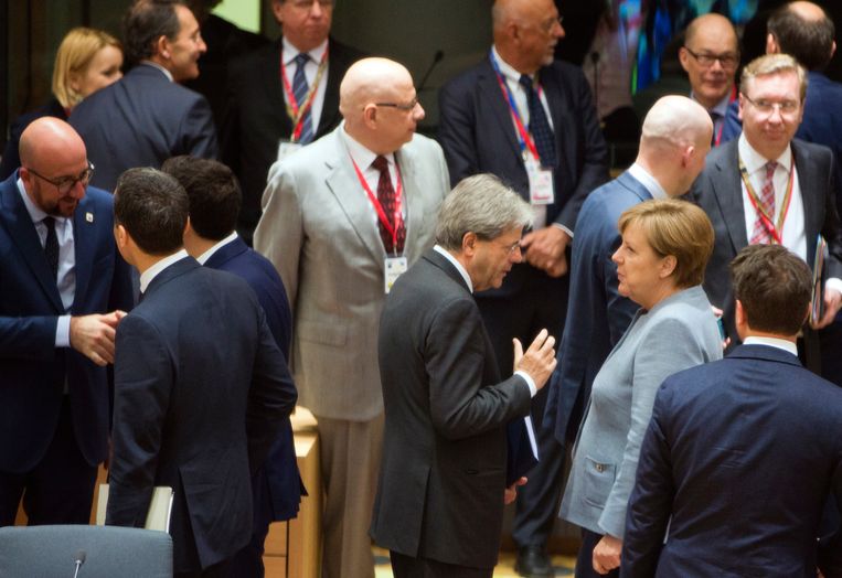 De Duitse bondskanselier Angela Merkel in Brussel in gesprek met de Italiaanse premier Paolo Gentiloni. Links in beeld premier Charles Michel.  Beeld AP