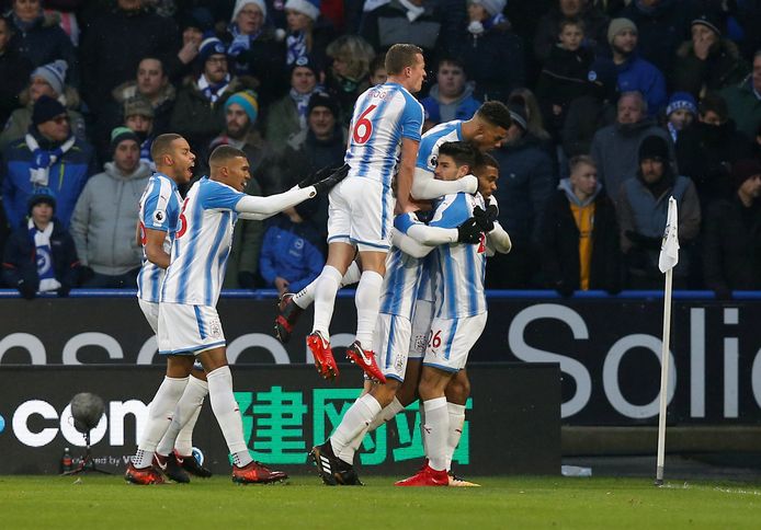 Soccer Football - Premier League - Huddersfield Town vs Brighton & Hove Albion - John Smith’s Stadium, Huddersfield, Britain - December 9, 2017   Huddersfield Town’s Steve Mounie celebrates scoring their first goal with teammates   REUTERS/Andrew Yates    EDITORIAL USE ONLY. No use with unauthorized audio, video, data, fixture lists, club/league logos or "live" services. Online in-match use limited to 75 images, no video emulation. No use in betting, games or single club/league/player publications. Please contact your account representative for further details.
