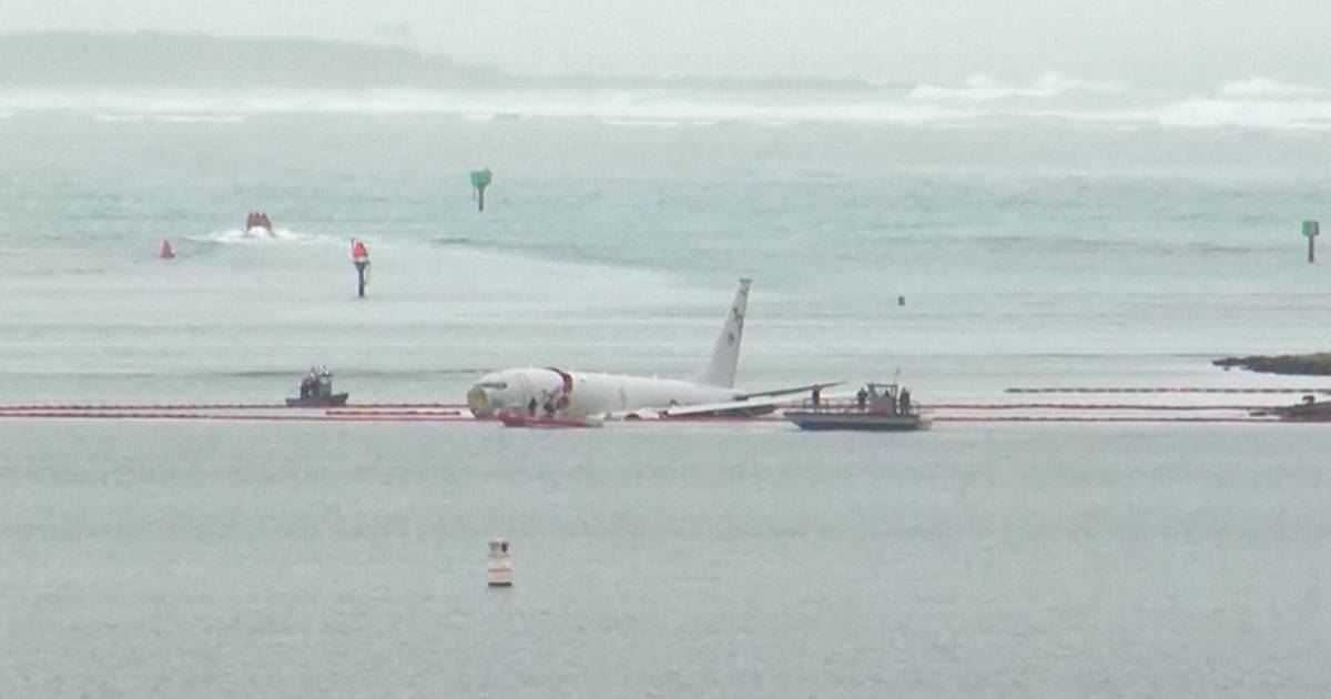 look.  A military plane slides into the sea after a failed landing, and its crew is forced to swim back to land  outside