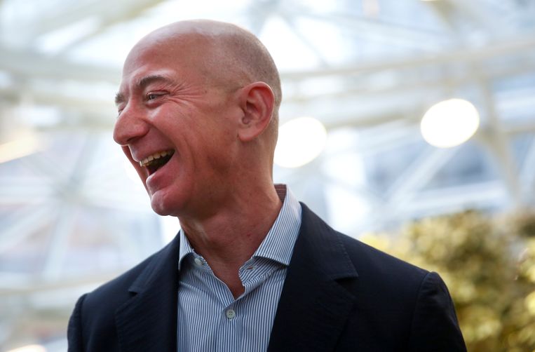 Jeff Bezos lacht zijn tanden bloot tijdens de opening van een nieuw hoofdkwartier van Amazon in Washington. Iedereen is benieuwd hoe de rijkste man ter wereld het ervan af zal brengen tijdens de hoorzitting in Washington. Beeld REUTERS
