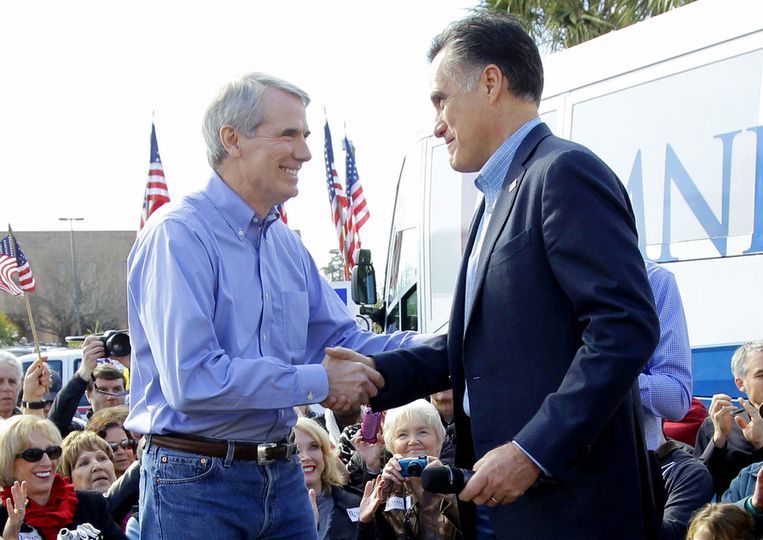 Mitt Romney schudt Rob Portman de hand. Beeld ap