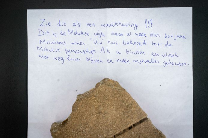 De steen en het bijbehorende briefje dat door de ruit van een woning in Elst werd gegooid.
