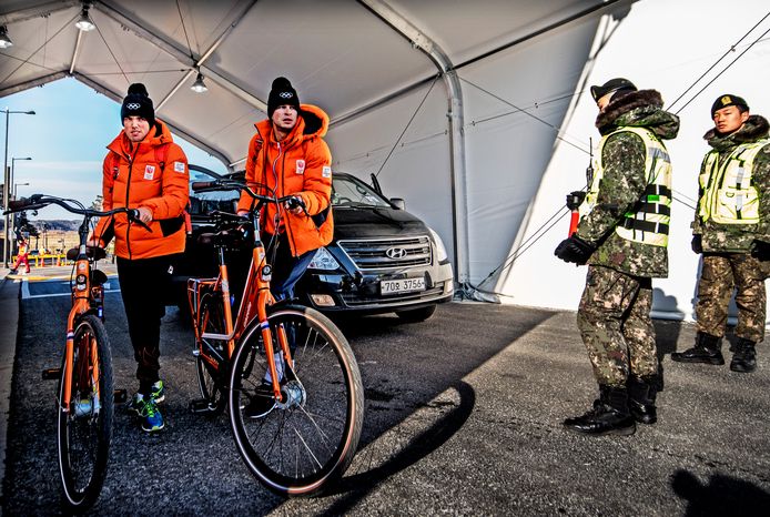 Patrick Roest en Sven Kramer passeren de Koreaanse militairen bij de controle voor het Gangneung-ijsstadion.