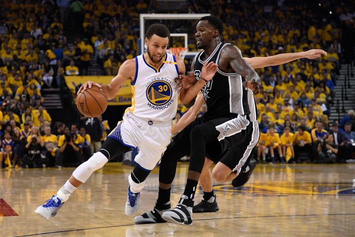 Stephen Curry (30) van de Golden State Warriors passeert Dewayne Dedmon (3) van de San Antonio Spurs.