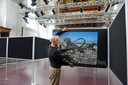 Marcel Kollen richt de tentoonstelling van National Geographic in op de panelen in de Nieuwe Kerk in Zierikzee. Op de foto de kanibaliserende leguanen.