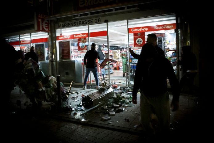 21 June 2020, Baden-Wuerttemberg, Stuttgart: People stand in front of a looted shop in Marien street after several people rioted in downtown Stuttgart during night. Photo: Julian Rettig/dpa