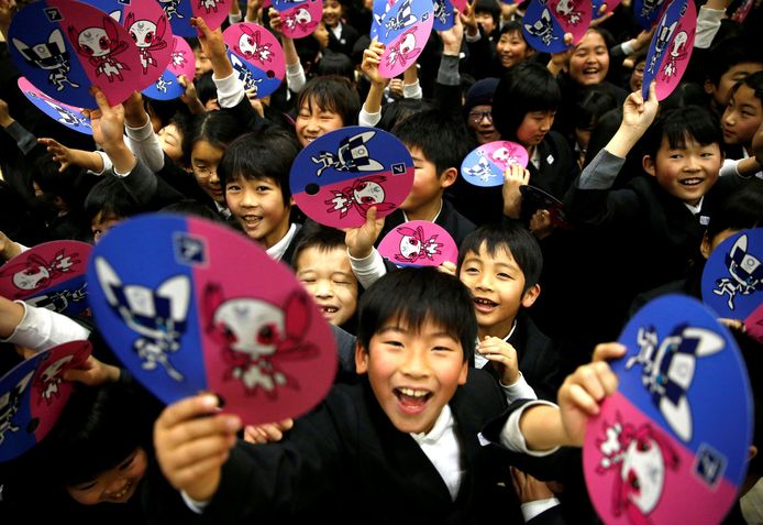 Japanse scholieren houden papieren waaiers voor de Olympische Spelen van 2020 in Tokio omhoog. Hiermee onthullen ze de mascottes die gekozen zijn voor de Spelen in Tokio. Foto Toru Hanai