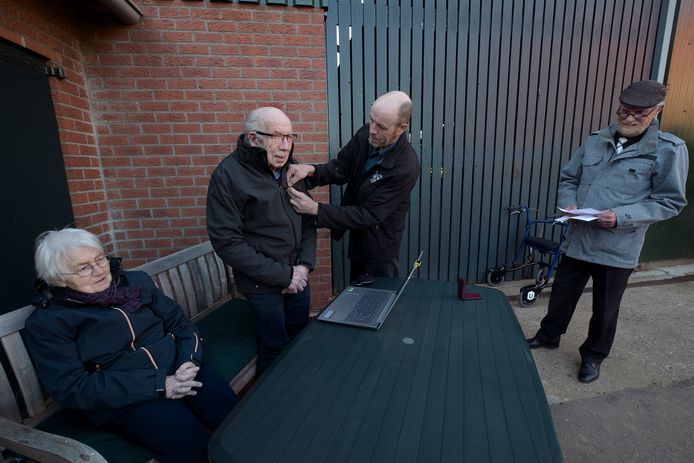 Gerrit Teunissen (86) is 70 jaar lid van Muziekvereniging Hummelo en Keppel. Hij krijgt daarvoor vanavond een onderscheiding van het bestuur van de muziekvereniging. Voorzitter Dirk Jan Huntelaar (rechts) kijkt toe hoe de onderscheiding wordt opgespeld.
