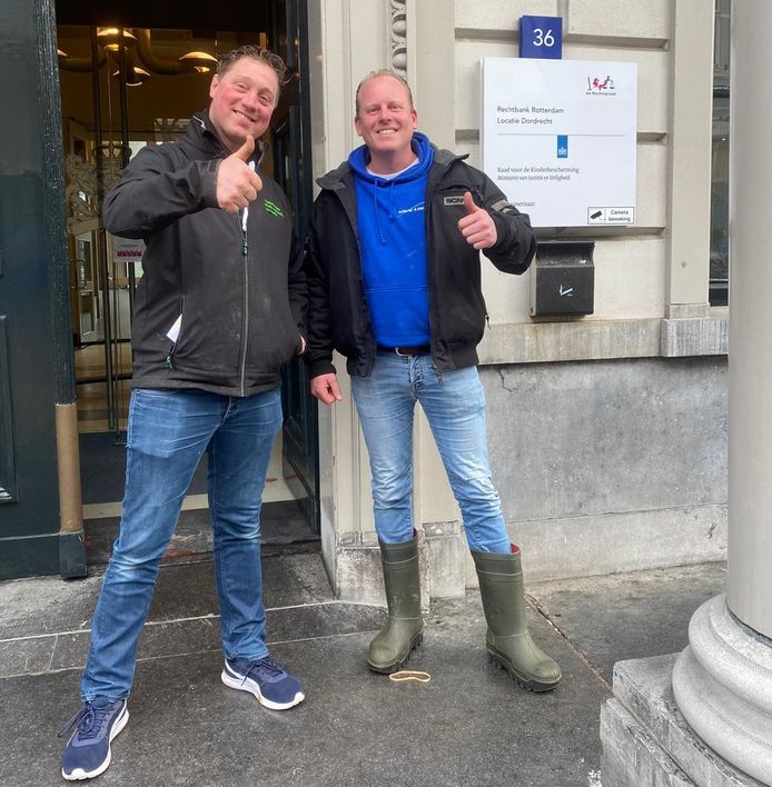 Een blije Thijs Wieggers (links) met kompaan Rutger van Lier voor  de rechtbank in Dordrecht, waar eerstgenoemde werd vrijgesproken voor het bedreigen van een motoragent.