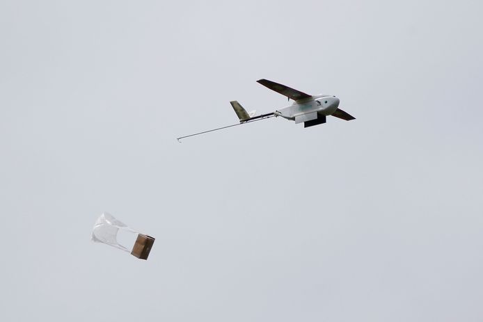 Het beschermingsmateriaal voor de ziekenhuizen valt uit de drone en komt met een parachute veilig op de grond.