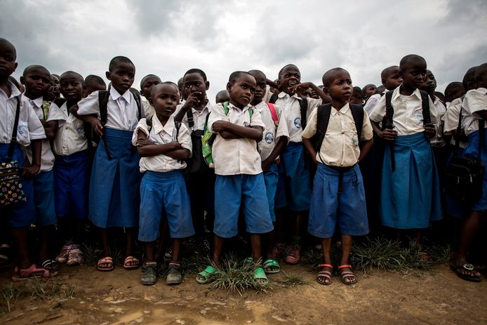 Congolese schoolkinderen luisteren naar een les waarin wordt uitgelegd hoe een ongeëxplodeerd explosief eruit ziet nadat een granaat werd gevonden op een schoolterrein.
