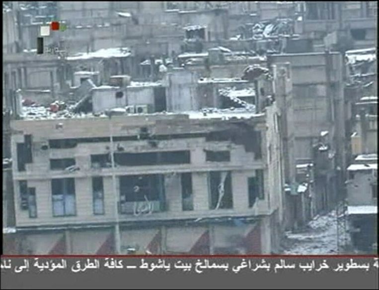 Beschadigde gebouwen in de wijk Baba Amr in Homs, op een still van beeld van Syria TV. © Reuters Beeld 