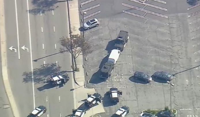 L'auto bianca è bloccata dai blindati della polizia.