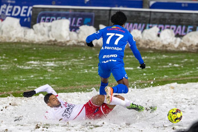 Moeskroen-verdediger Saad Agouzoul duelleert in de sneeuw met Genk-speler Angelo Preciado.