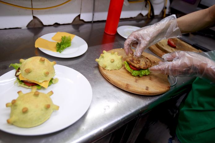 epa08324021 A chef make coronavirus-themed burgers  at a pizza restaurant in Hanoi, Vietnam 26 March 2020. The burger is currently sold for 65,000 VND each (around 2,5 Euros)  EPA/LUONG THAI LINH  ATTENTION: This Image is part of a PHOTO SET