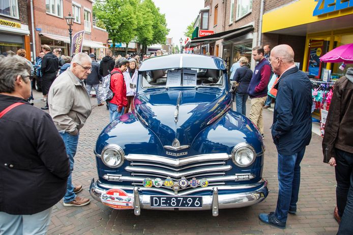 Bezoekers bewonderen op de Dorpsstraat een Plymouth Special de Luxe tijdens de Oldtimerdag in 2018.