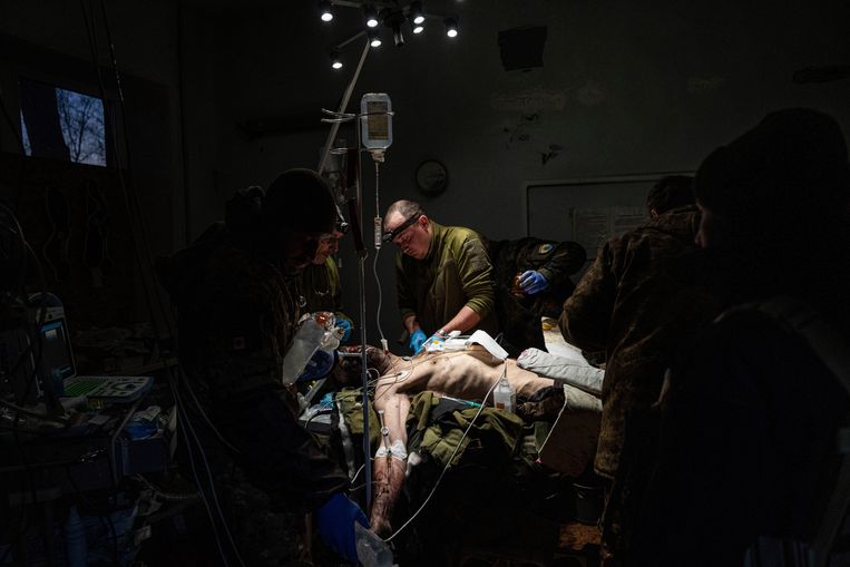 Artsen opereren een gewonde Oekraïense soldaat.  Beeld Evgeniy Maloektka / AP
