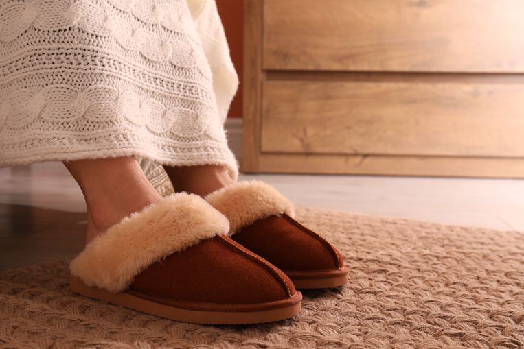 Woman in warm soft slippers at home, closeup Beeld Getty Images/iStockphoto
