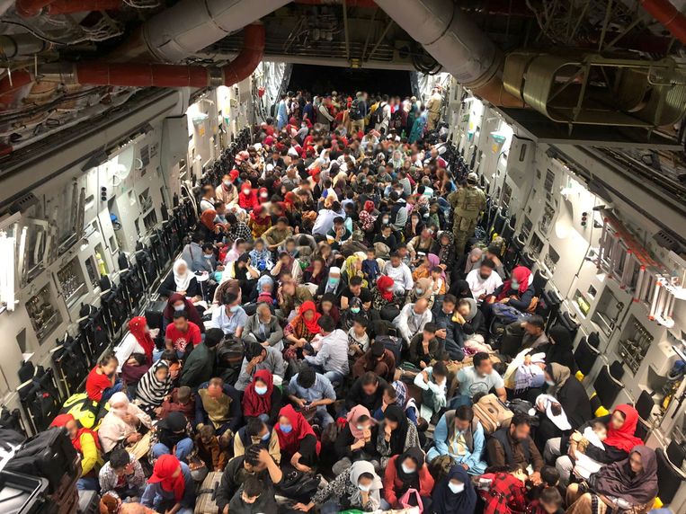Evacuees in een transportvliegtuig op het vliegveld van Kaboel. Beeld Reuters