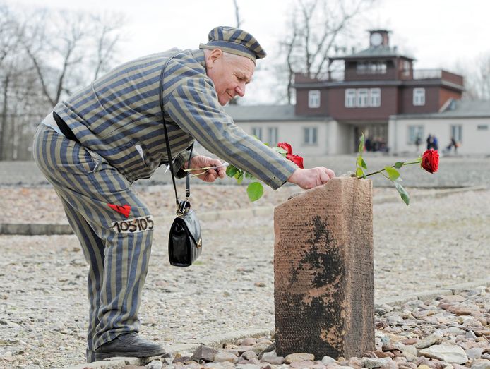 Een Oekraïense overlever van het concentratiekamp in Buchenwald legt een roos neer bij een gedenksteen. De negen hebben in de Duitse kampen Ravensbrück en Buchenwald, in Mauthausen in Oostenrijk en in het Poolse Auschwitz gewerkt.
