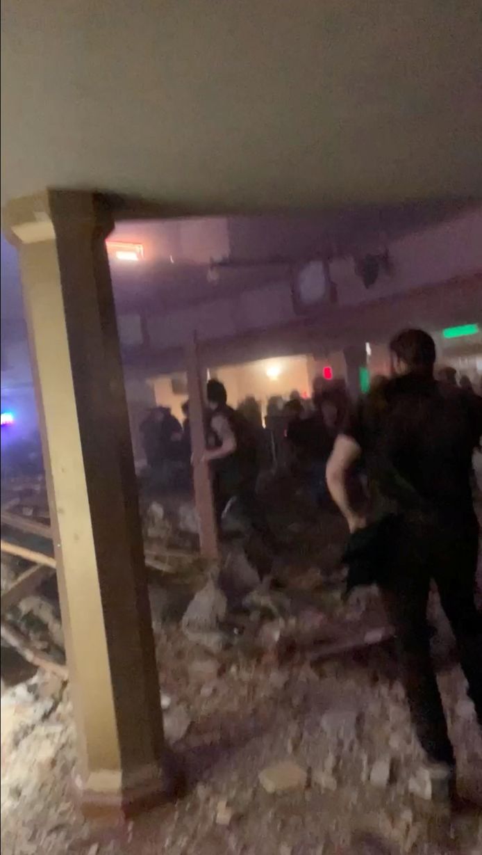 People search for the exit of the collapsed concert hall among the rubble, in this image shared on social media.