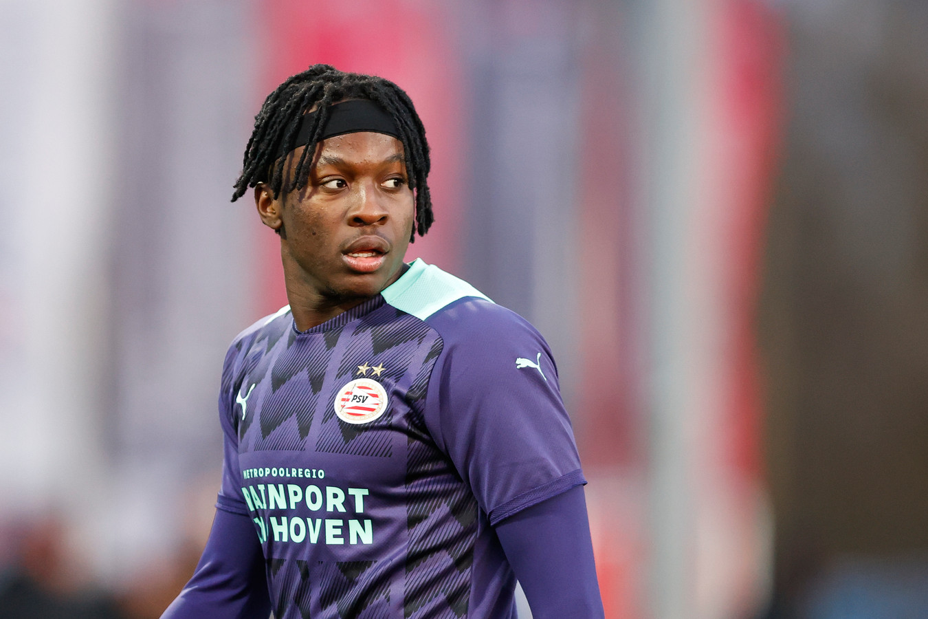  Johan Bakayoko, a professional soccer player, dribbles the ball past defenders during a match for PSV Eindhoven.