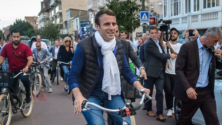 De Franse president en zijn echtgenote maakten gisteren nog een fietstochtje in Le Touquet waar ze vandaag hun stem uitbrengen. Beeld EPA