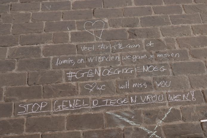 Mensen laten boodschappen achter in krijt tijdens een wake in Gent.