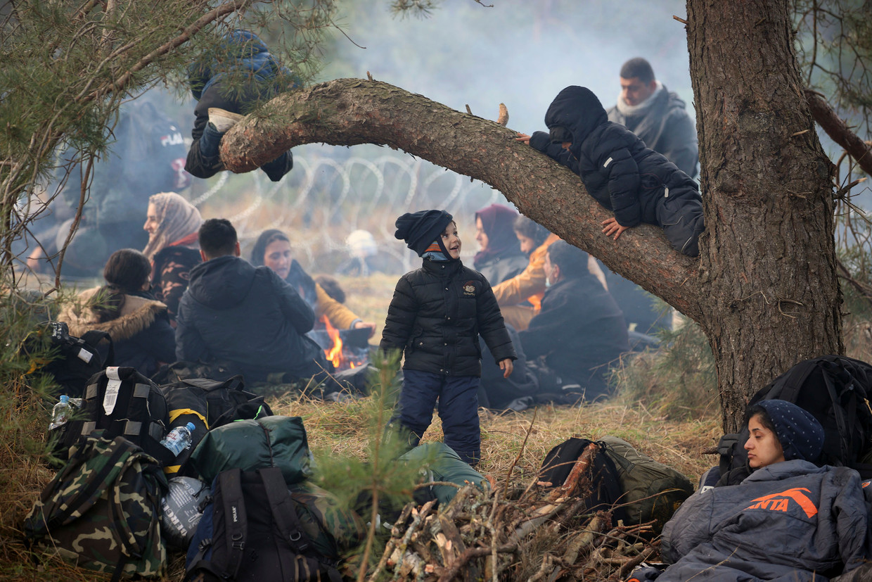 Migrants rest at the Polish-Belarus border near Grodno, Belarus.  AP . image