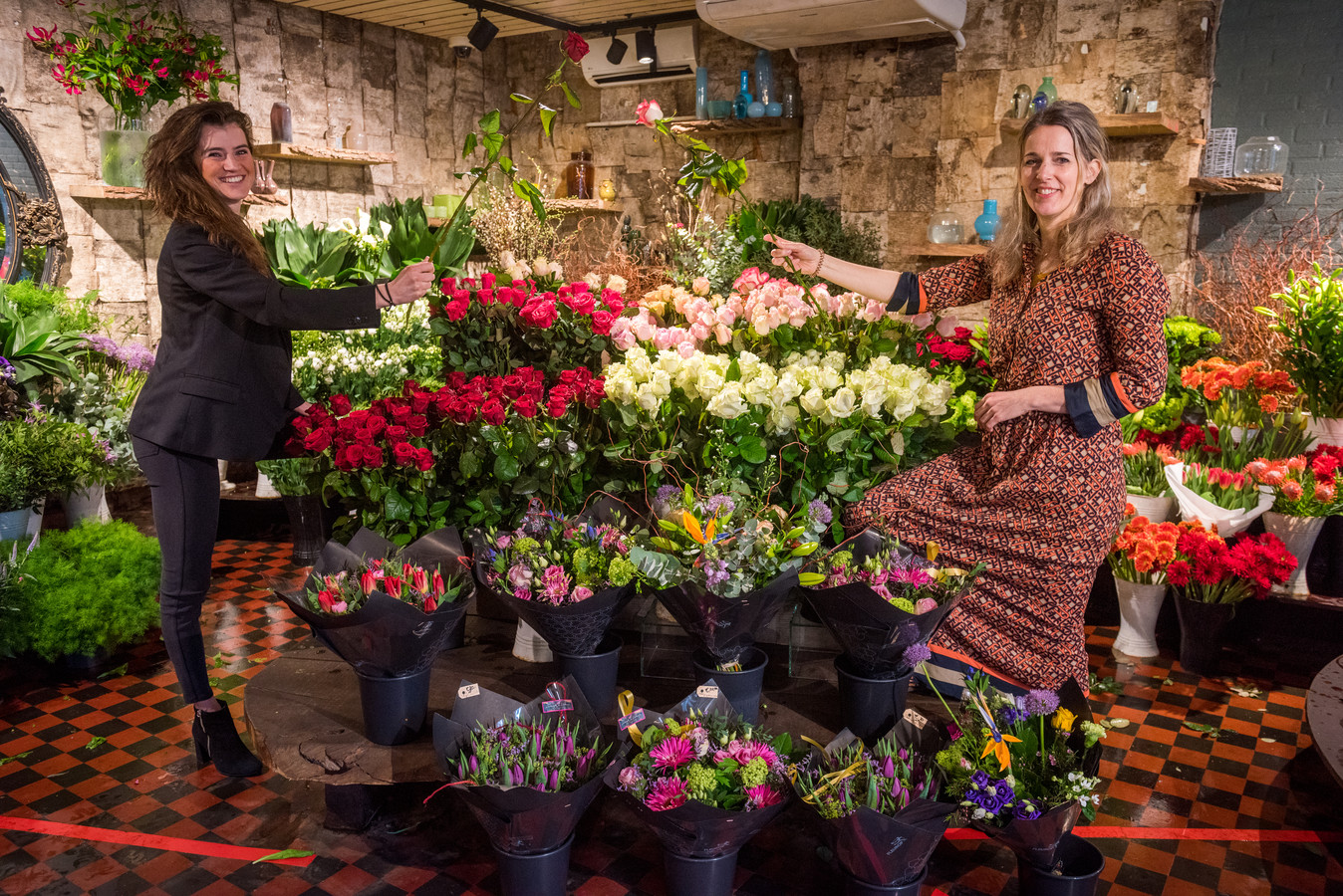 Anneloes Verhoeven (links) en Marian Gruiters met de vijfhonderd rozen van Liebregts en Liebregts Bloemsierkunst.