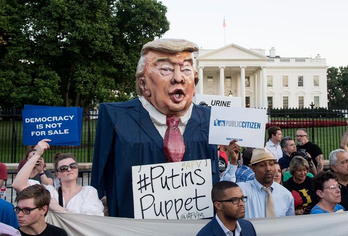 epa06897412 An oversized puppet depicting the image of US President Donald J. Trump that is labeled 'Putin's Puppet' is among a crowd of hundreds of people participating in a national vigil 'to demand democracy' and to 'confront corruption', on Pennsylvania Avenue outside the White House in Washington, DC, USA, 18 July 2018. Vigils were organized at various locations throughout the USA to voice criticism of President Trump for his handling of a news conference with President of Russia Vladimir Putin in Helsinki, 16 July. Critics accuse Trump of failing to stand up to the Russian leader and betraying US intelligence agencies by publicly casting doubt on their findings.  EPA/MICHAEL REYNOLDS