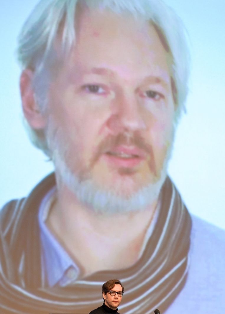 Jacob Appelbaum tijdens de dertigste editie van de Chaos Computer Club (CCC) in Hamburg. Op de achtergrond een grote afbeelding van Julian Assange. Beeld afp