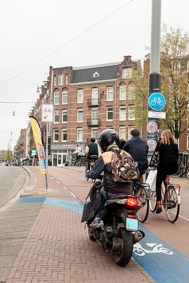 Sinds 8 april moet de snorfietser in Amsterdam mét helm de rijbaan op. Beeld Jakob Van Vliet