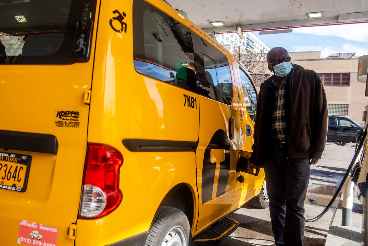 A New York taxi driver looks at the pump with some concern, as petrol prices are almost half higher than last year.  Image AP