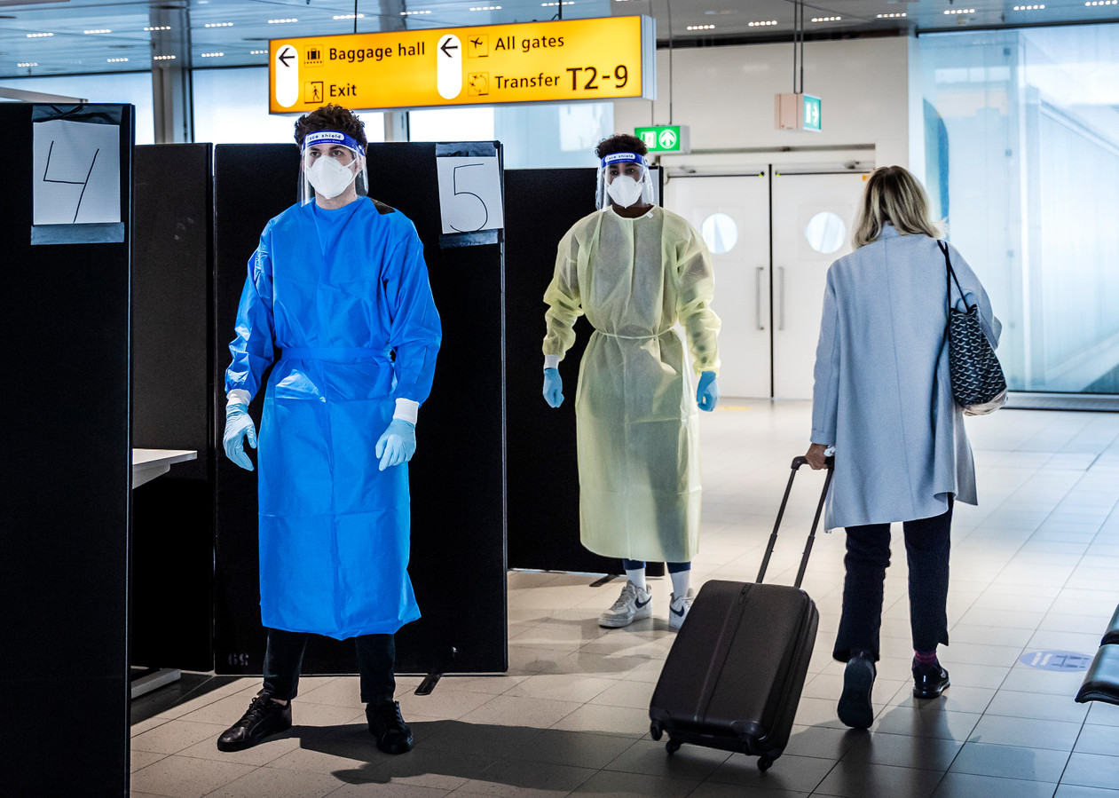 Reizigers uit Zuid-Afrika laten zich bij aankomst op de luchthaven testen op het coronavirus in een speciaal daarvoor ingerichte teststraat.