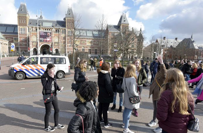 Toeristen buiten het Rijksmuseum dat ontruimd is vanwege een stroomstoring.