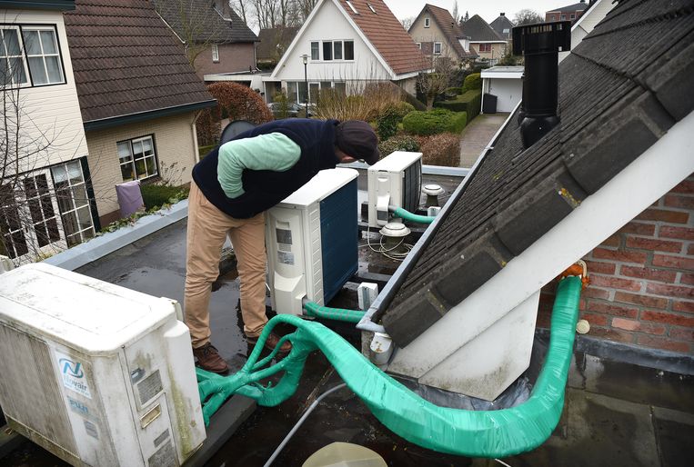 Een warmtepompsysteem wordt geïnstalleerd op een dak in Apeldoorn.  Beeld Marcel van den Bergh