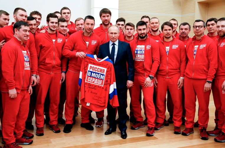 Russische ijshockeyers poseren met president Poetin. De ploeg werd vorig jaar olympisch kampioen. Vanwege de schorsing speelden ze onder de neutrale naam ‘olympic athletes from Russia’. Beeld AFP