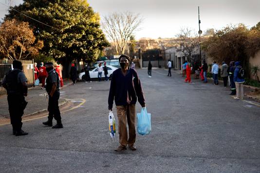 Een man loopt weg nadat hij voedselhulp heeft ontvangen van een lokale kerk in Johannesburg, Zuid-Afrika. (06/08/2020)