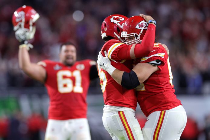 Patrick Mahomes (l) hugs his teammate after the Super Bowl victory.