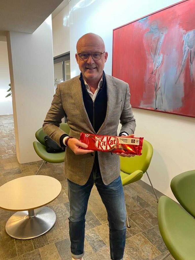Algemeen directeur Wilco van Schaik van NEC heeft een doos KitKat meegenomen voor burgemeester Hubert Bruls van Nijmegen voor de evaluatie van de supportersrellen na de derby NEC-Vitesse.
